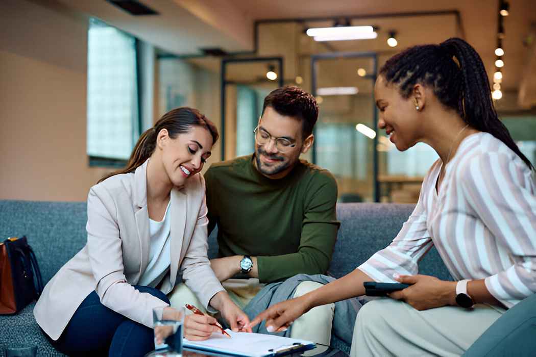 A couple discussing loan options with a financial advisor.