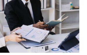 A person studying for a real estate licensing exam at a desk.